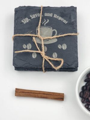 Laser-engraved slate coffee coaster set (4-pack) with “Sip, Savor & Repeat” design, tied with twine